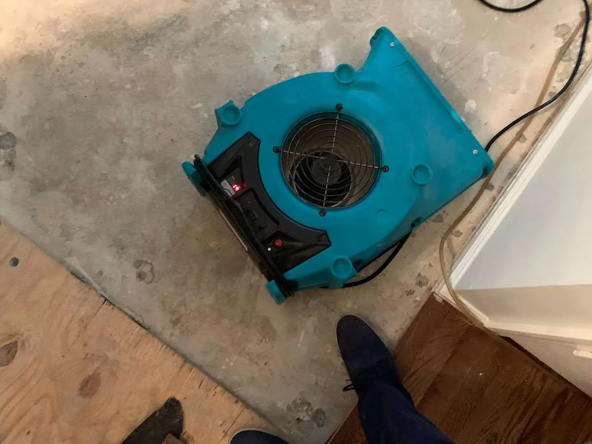 Air mover drying subfloor during Commercial Water Damage Restoration in Del City